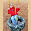 Child playing on Deluxe 3-Chain Tire Swing - camouflage color
