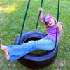 Child playing on Deluxe 3-Chain Tire Swing - black color