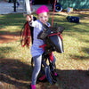 Child playing on Pirate Pony Swing with pirate hat and earring